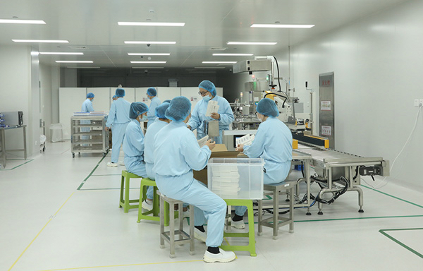 Changxing facility employees prepare Clover's COVID-19 vaccine for shipment